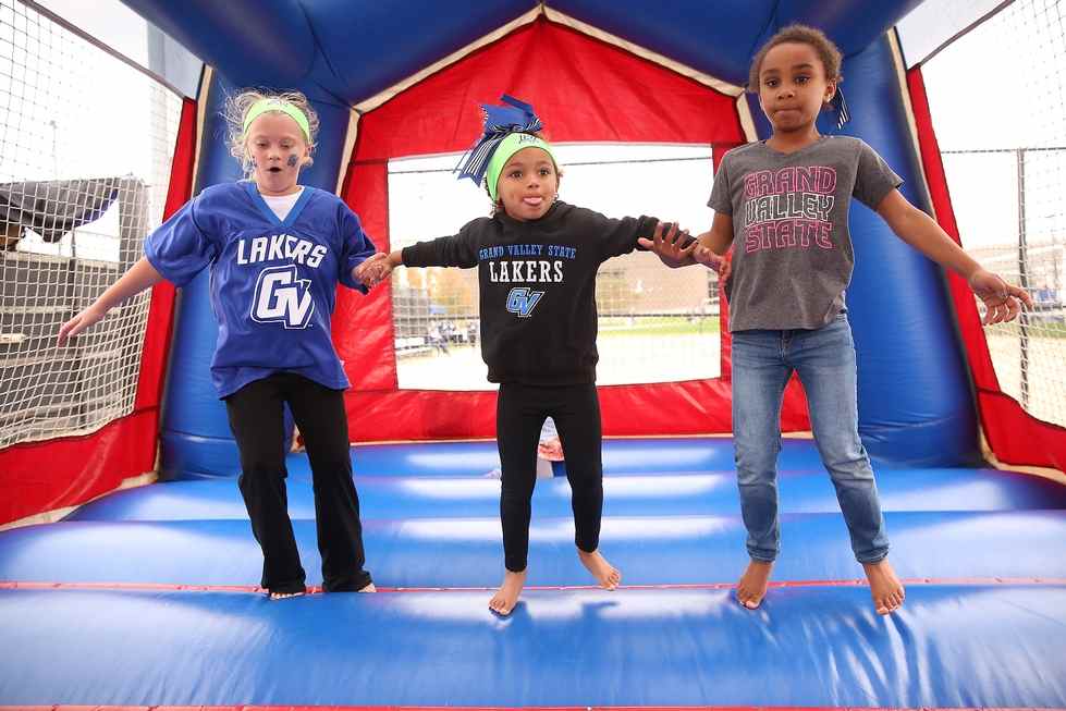 3 kids bouncing in bouncy house